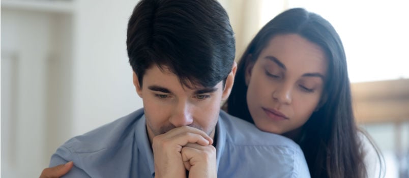 Woman comforting man