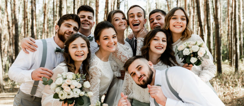Young group of couple hugging each other tightly