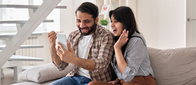 Happy couple looking at phone