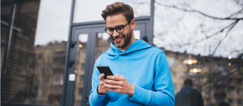 Happy man using smartphone