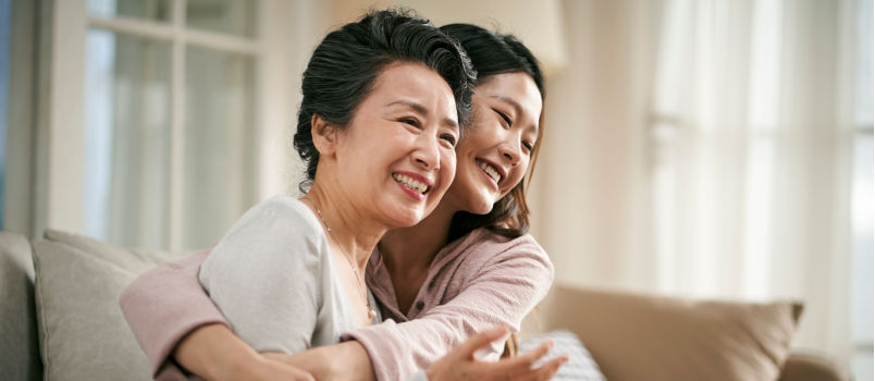 Mother hugging daughter