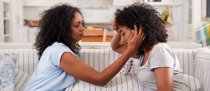 Mother talking with unhappy teenager