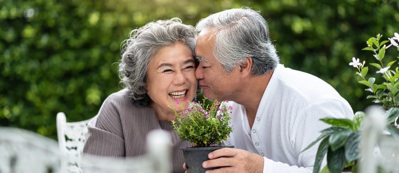 Man kissing wife cheeks