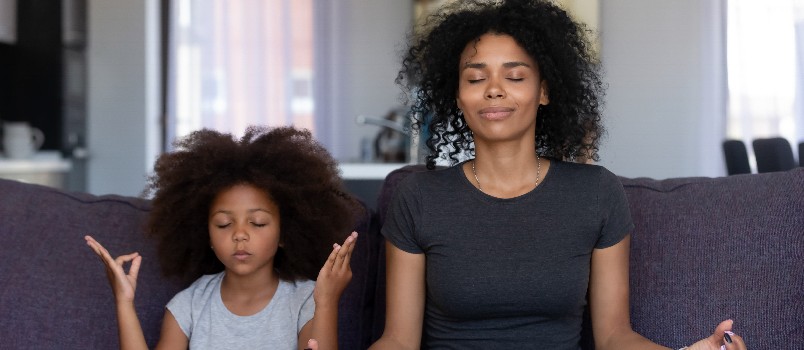 Mother and daughter doing yoga together