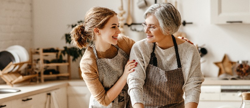 Mother and daughter working in kitchen