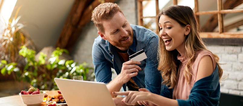 Happy couple doing online shopping