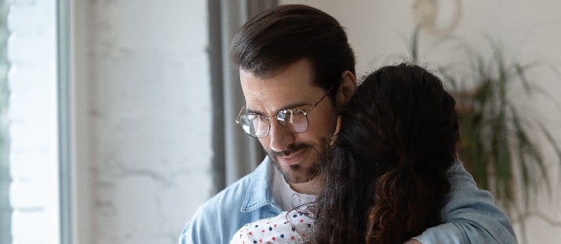 Young man cuddling woman