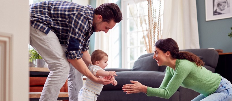 Happy couple playing with kid