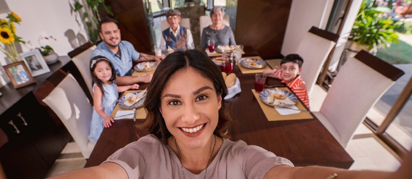 Mother taking selfie with full family 