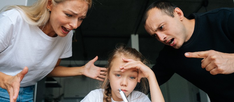 Parents scolding their kid 