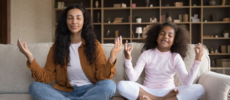 Mother and daughter doing yoga