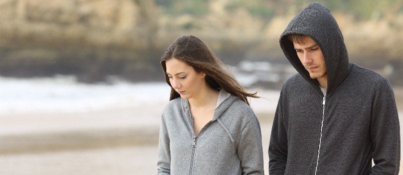 Sad couple walking on road