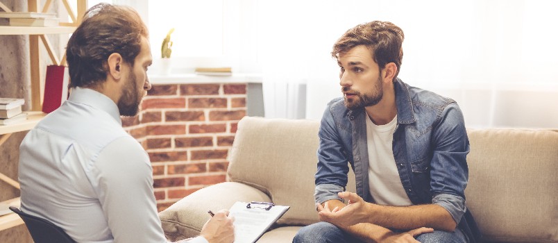 Handsome young man taking counseling session