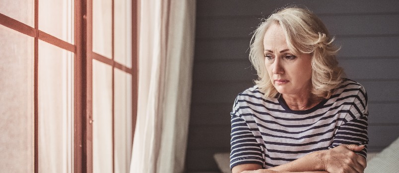 Sad depressed woman sitting alone 