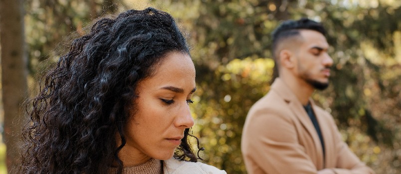 Upset couple standing outside