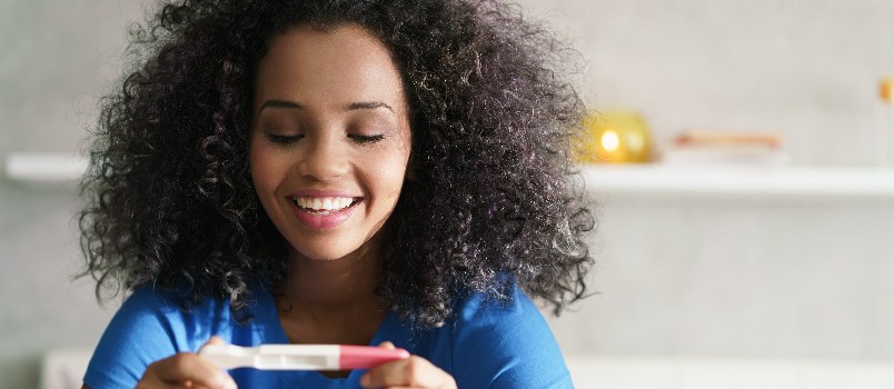 Woman holding pregnancy test kit