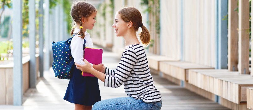 Mother sending daughter to school 