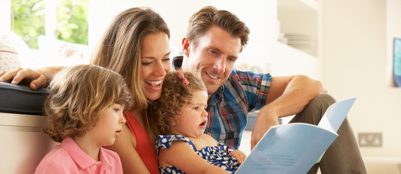 parents sitting children reading story indoor