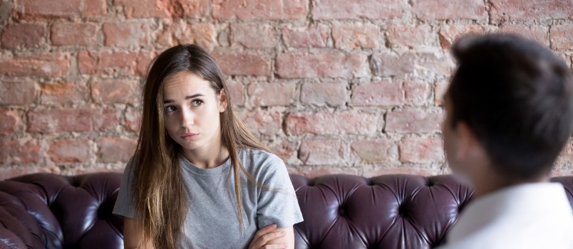 young woman visiting psychologist counselor upset