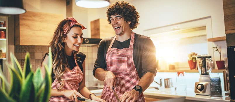 Happy couple working in kitchen together  