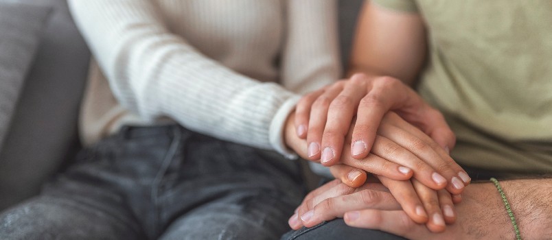 Couple holding each other hands