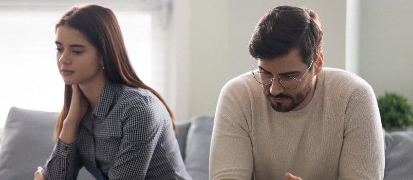 Young couple being sad sitting