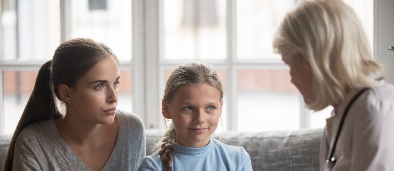Mother and daughter attending meeting