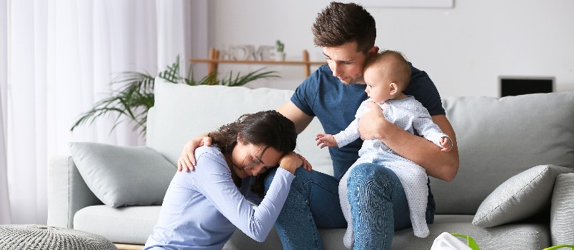 Stressed couple suffering postnatal
