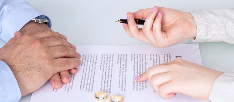 Wife signing the divorce paper where husband disagree