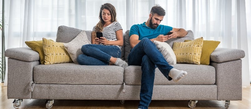 Couple sitting on couch in living room