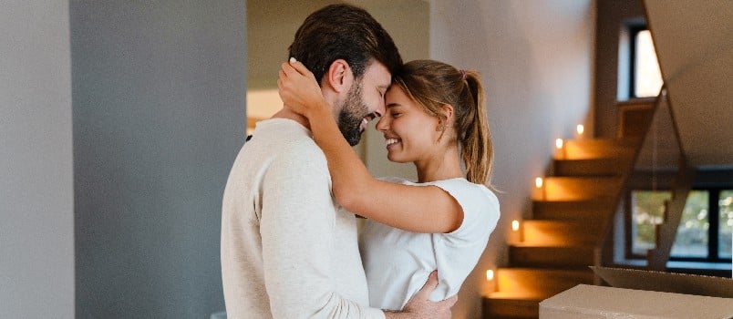 Cheerful couple smiling while hugging