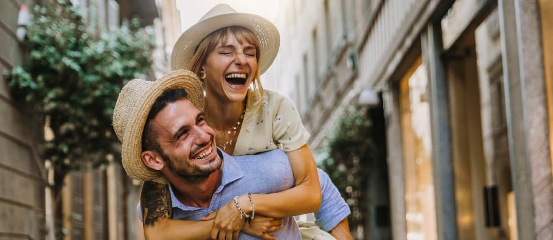 Happy couple walking through street 