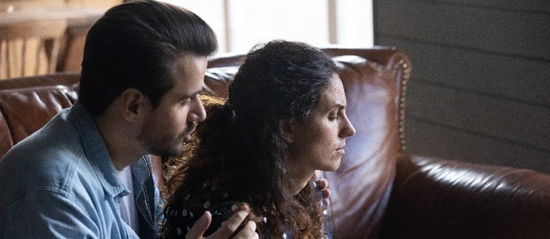 Husband giving comfort to his wife