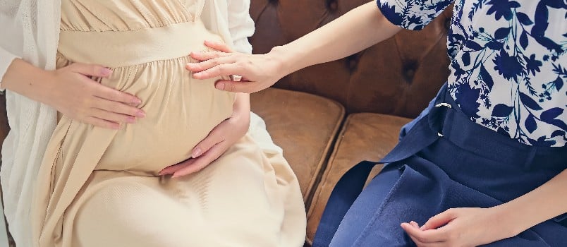 Pregnant woman talking about motherhood concept