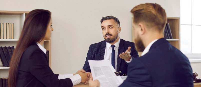 Lawyer speaking to client couple