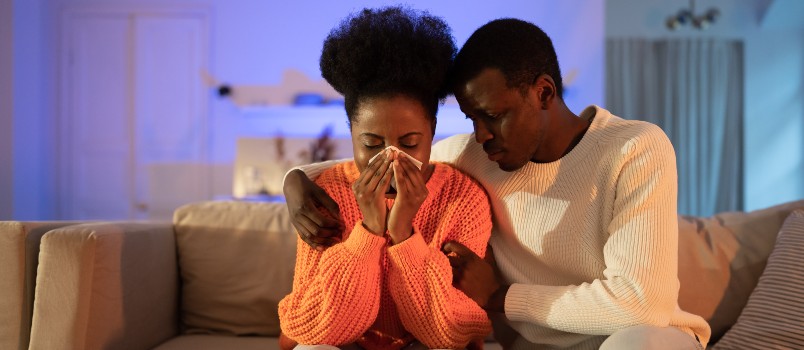 Man comforting sad woman