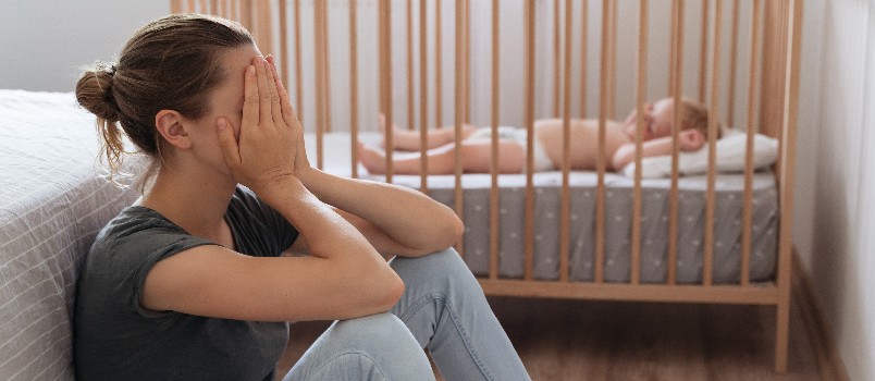 Young mother covering her crying face