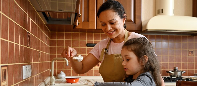 Mother daughter cooking in kitchen