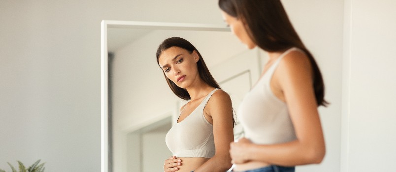 Woman looking herself in mirror 