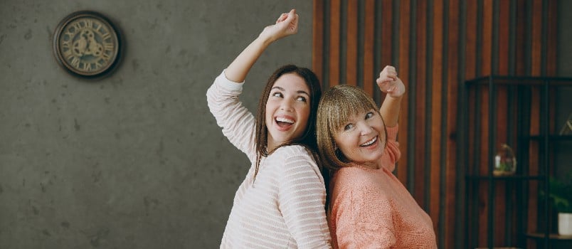 Mother and daughter dancing together 