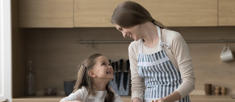 Mother and daughter working in kitchen