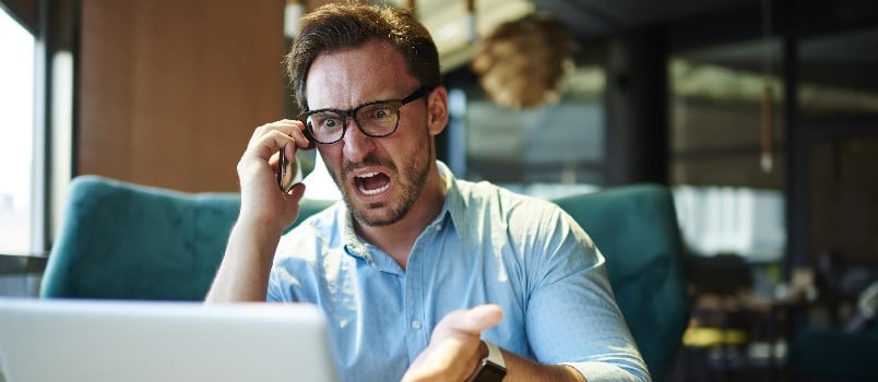 angry man talking on a phone