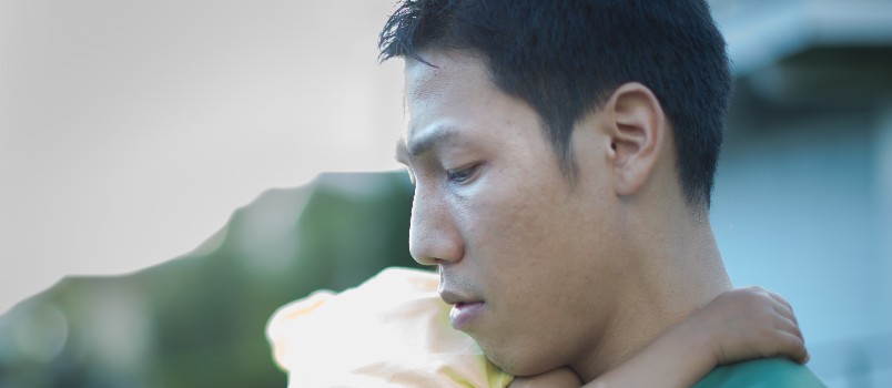 Unhappy father holding baby