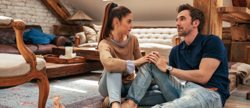 Young bold couple talking together