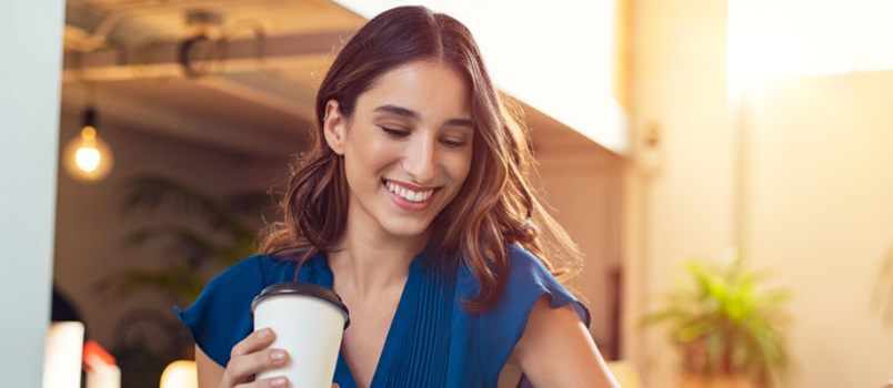 Young beautiful woman holding coffee mug