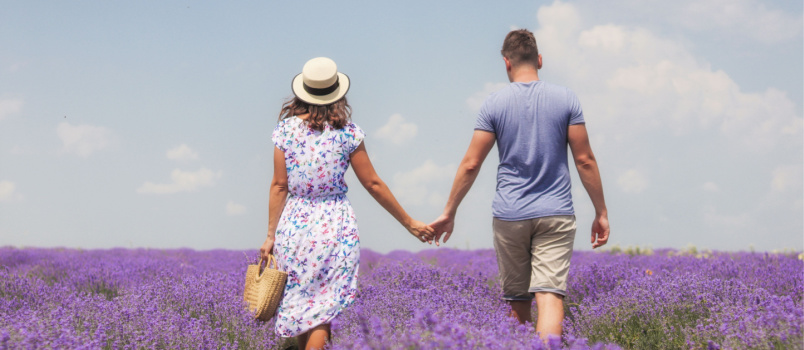 Young lovely couple walking in lavender garden