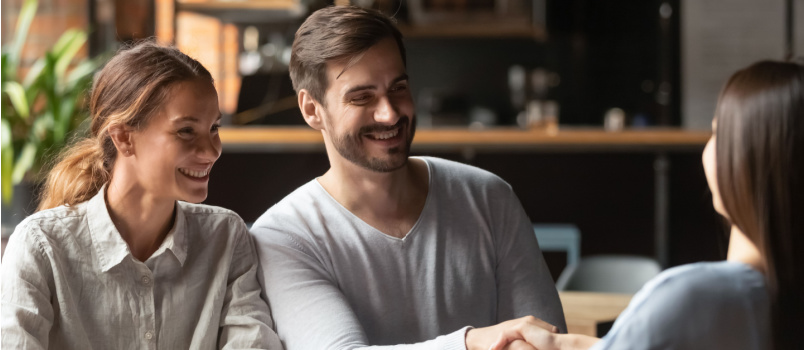 Happy couple meeting lawyer 