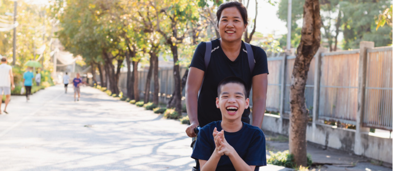 disabled child on wheelchair playing outdoor
