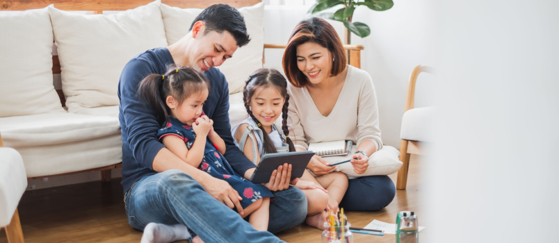 Happy asian family using tablet