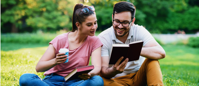 Young loving couple reading book together